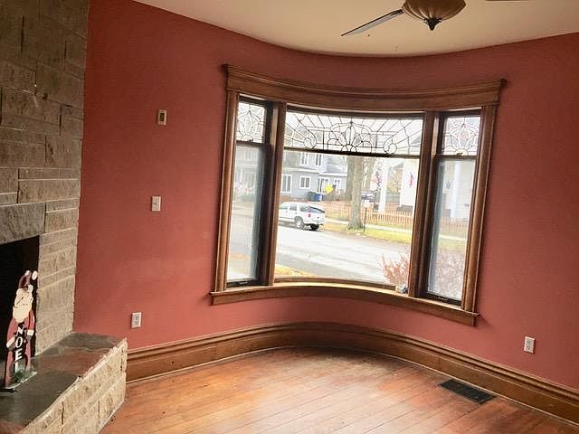 Fireplace and front window facing out to Center Street--a BEAUTIFUL place for your tree