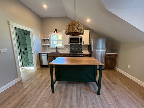 Kitchen with brand new GE stainless steel appliances. Island for storage and seating.