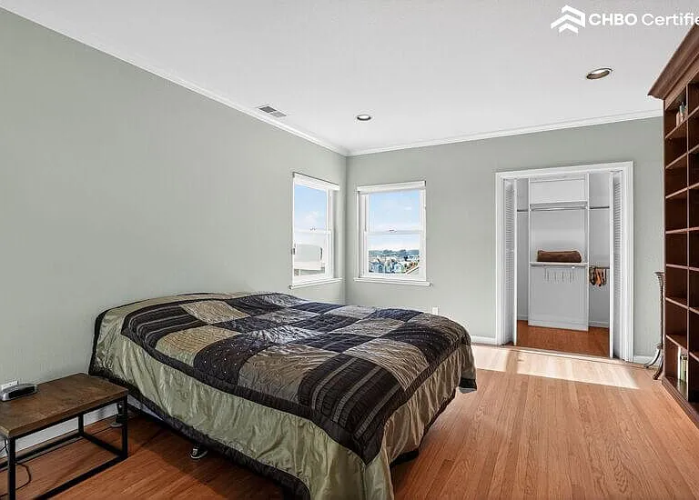 The upper level guest bedroom has a large walk-in closet