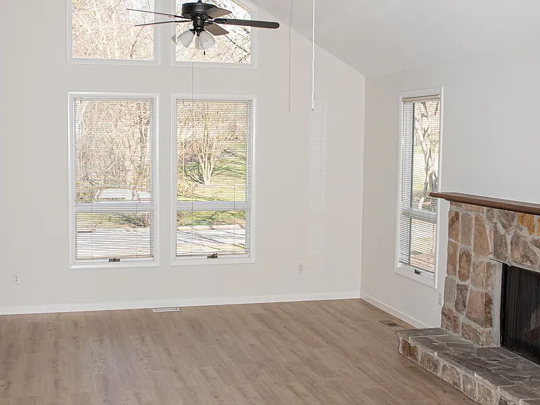Family room with vaulted ceilings, lots of natural light, gas fire place and two ceiling fans