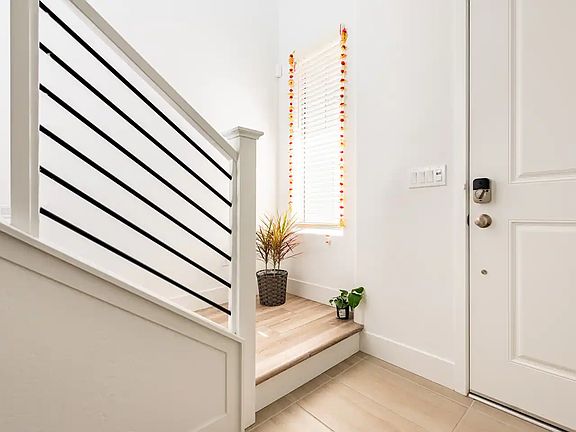 Entrance door of the house. There is a bedroom downstairs. Another bedroom and kitchen is upstairs.