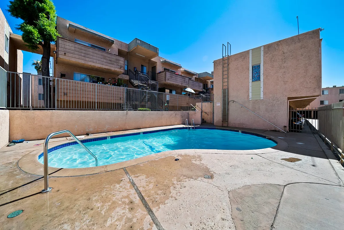 Photo 1 of 10 - Summer Breeze Apartments - Sepulveda, CA Well-maintained community pool designed for relaxation and everyday enjoyment. - Summer Breeze Apartments