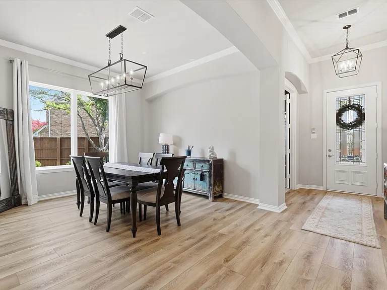 Beautiful dining room with a view of the backyard oasis.