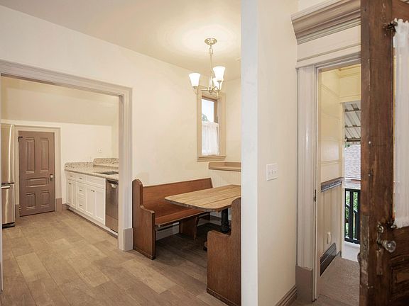 Tile entry leading to dining booth and kitchen