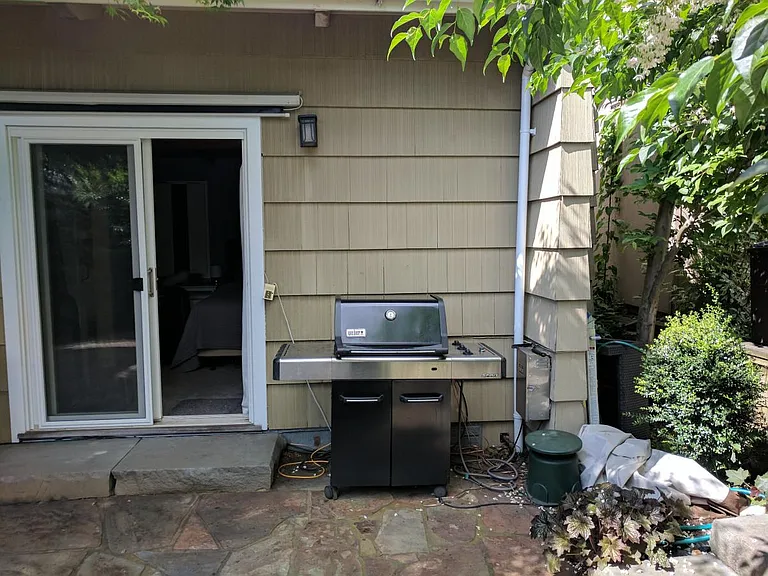 Back Yard and Weber Grill, with lead in to Master Bedroom.