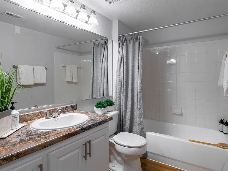 Refresh your routine in this stylish bathroom, complete with a full-size tub, granite-style countertops, and upgraded lighting.