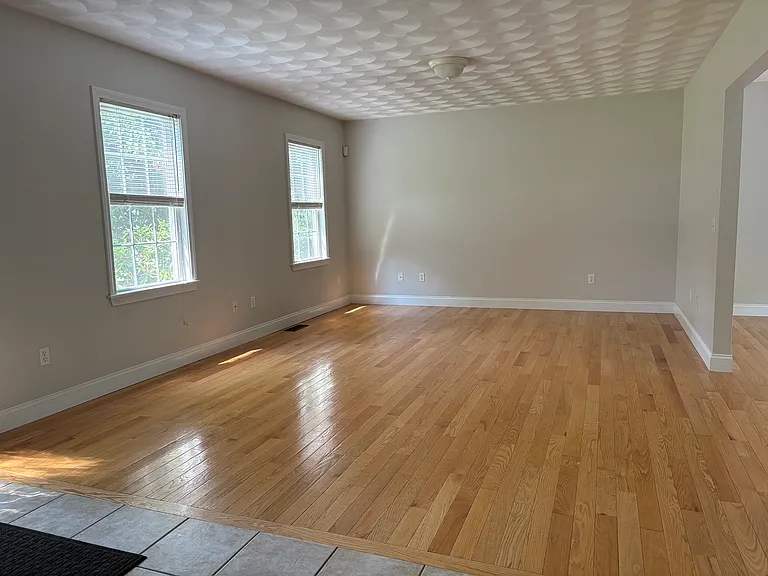 Large living room with hardwood floors, first floor
