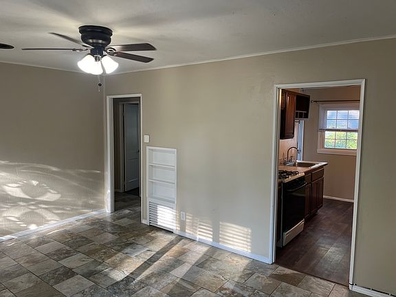 Living room looking into kitchen and hallway