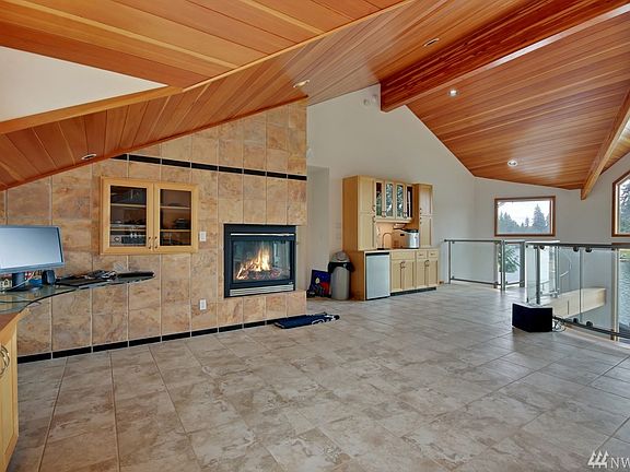 Upstairs 528 Sq. Ft. Industrial Built Entertainment/Great Room - pool table included.  Also includes: Big Screen TV/Sink/Gas Fireplace/Dishwasher & Freezer!  Look at that retractable cat-walk leading to the 16X9 above garage bar Storage!