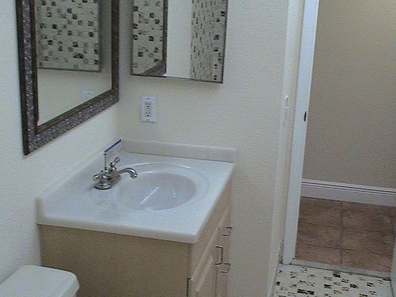 Brand New bathroom cabinet w/faux marble top and new fixtures.