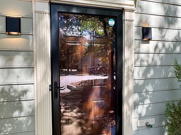 A storm door to enjoy for natural light and modern exterior lighting