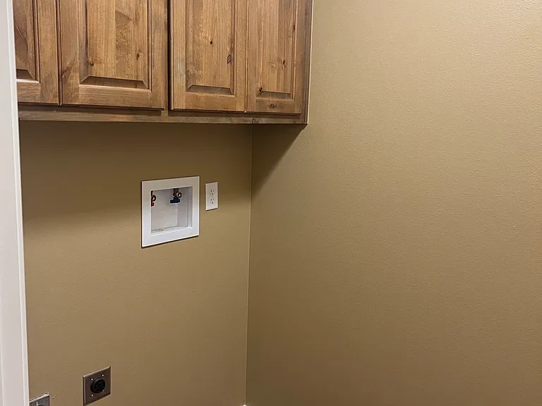 Laundry area with garage entry.