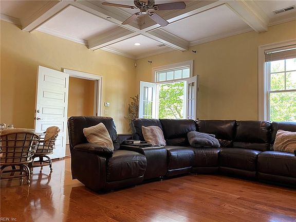 Open concept living/dining room with access to balcony.