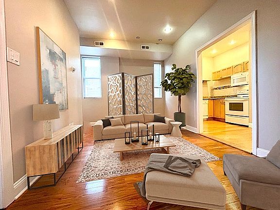Living room 
beautiful hardwood floors
high ceilings 
sun-lite