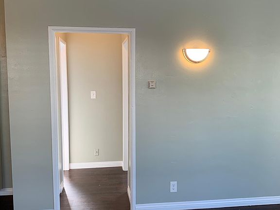 Hall leading to linen closet and bathroom on left and bedroom on right.