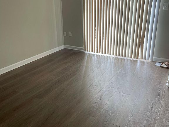 The Livingroom- the vertical blinds are now replaced with curtains