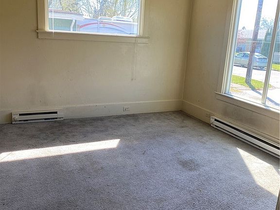 Bright open living room with big picture window. High ceilings give this room character.