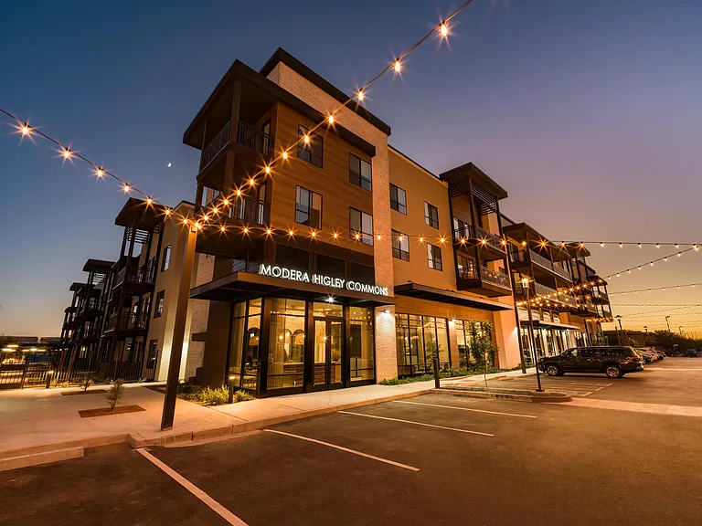 Evening lights frame Modera Higley Commons, where contemporary design and an inviting streetscape set the tone for refined everyday living.