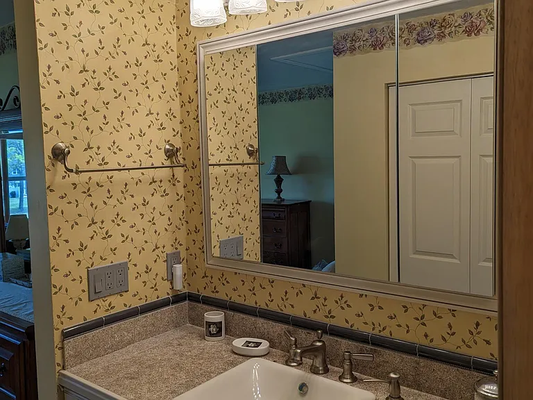 master ensuite custom vanity cabinets, comfort height counter, mirrored triple medicine cabinet, wide light fixture