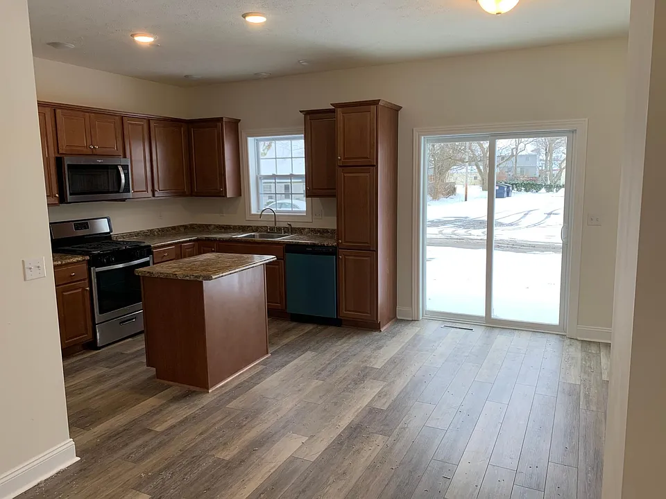 Kitchen with Walnut Cabinets and Dining Room