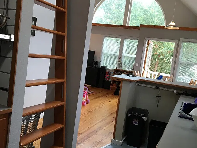 Kitchen looking into living and dining room/door to deck