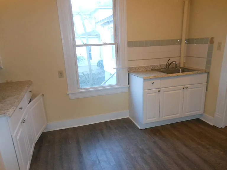 Kitchen--looking east. New sink, new faucett, new flooring, new paint, new countertops, new cabinet.