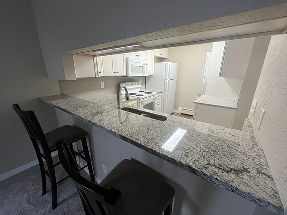 Open kitchen with bar top and stools