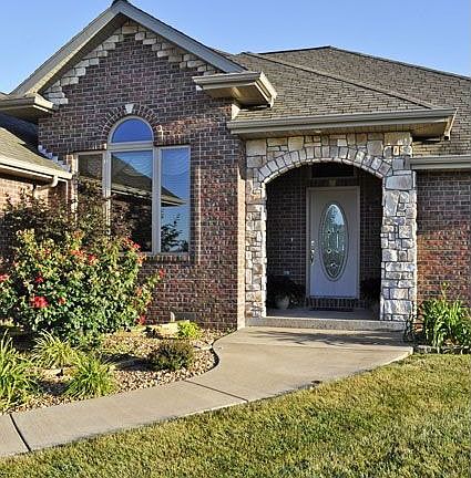 Lovely four bedroom all brick home with a three car garage and...