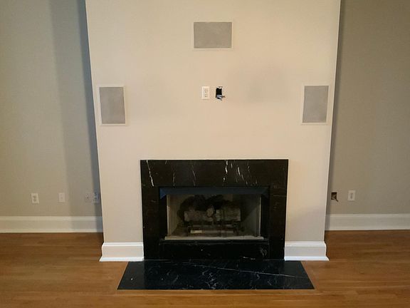 Close up of gas fireplace and TV/Surround Sound hookup