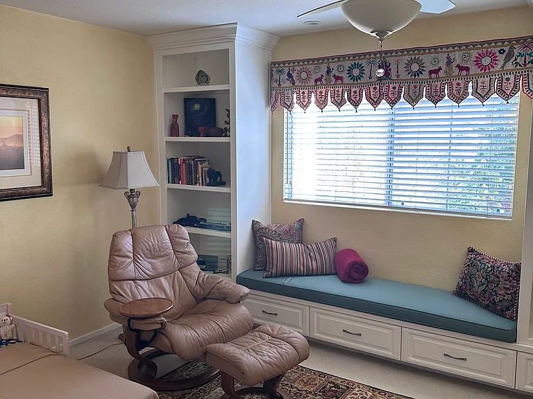 Bedroom 3 on second floor. Note built-in shelves and window seat.