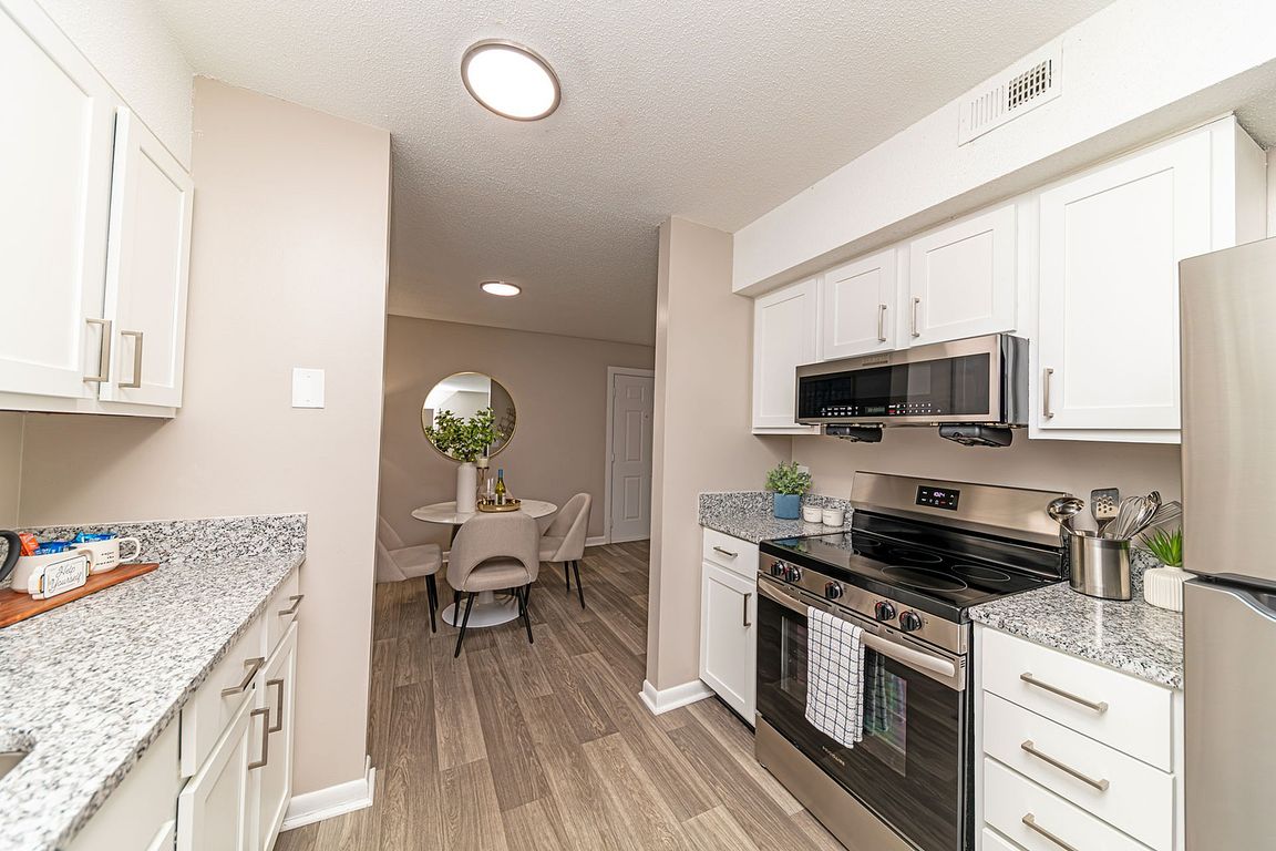 Kitchen with granite counters, stainless appliances, and modern cabinetry