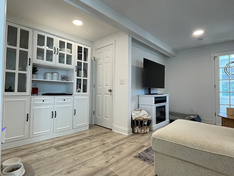 Living room with bonus area outside of a spacious pantry or storage closet