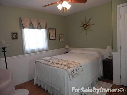 Bedroom : Beaded wainscotting and laminate flooring gives this room a New England feel.