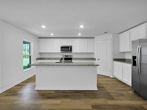 Overlooking the spacious family room, the sprawling granite countertops are sure to impress!
