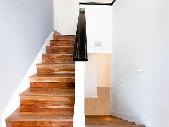 When you enter the front door there is a staircase up to the middle level with living room, dining room and kitchen and you can see the staircase that goes down to the lower level with its own living room, bathroom and bedroom.