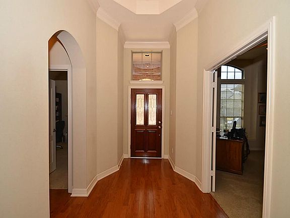The entry features an impressive rotunda with rich hardwood floors! A secondary bedroom  and full bath. On the other side is a large STUDY/Game room w/DOUBLE doors.