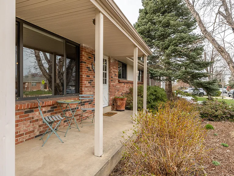 Front porch and privacy bushes.