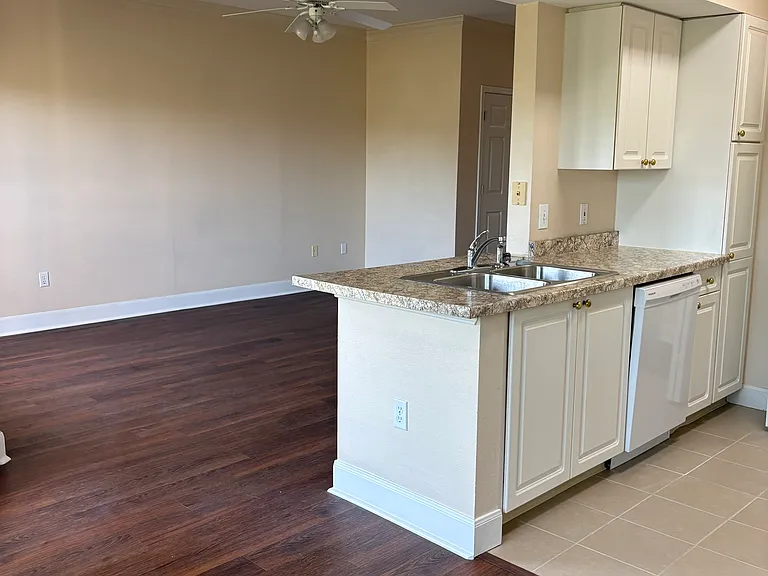 Looking at the living room and part of the kitchen from the dining area.
