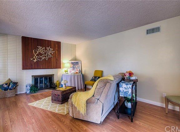 The dining room opens up to the warm and spacious living room with an inviting fireplace.