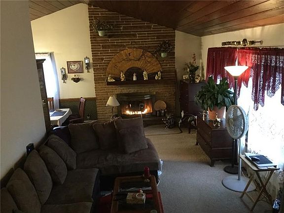 Living room is open to the dining room.  You'll love the wood finished cathedral ceiling!