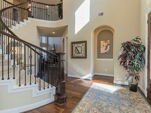 This additional view of the homes entry allows for a better feel as to how large it is. Additionally, you will notice the upgraded decorative wrought iron spindles on the stairs case.