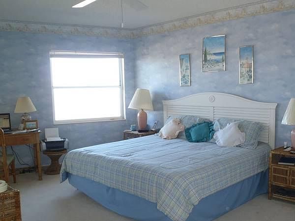 Master bedroom overlooking Gulf with sliding doors out to balcony