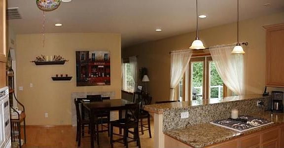 Dining Area with gas fireplace insert and slider that leads to back deck.