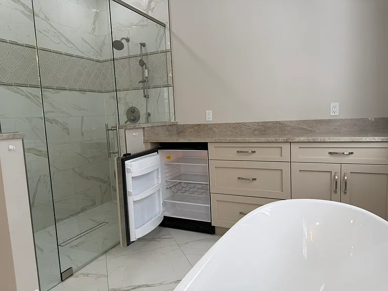 Shower with mini-refrigerator and separate soaking tub
