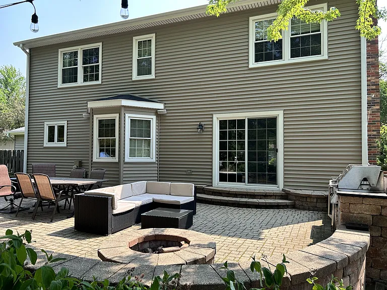 back patio with built in fire pit and grill