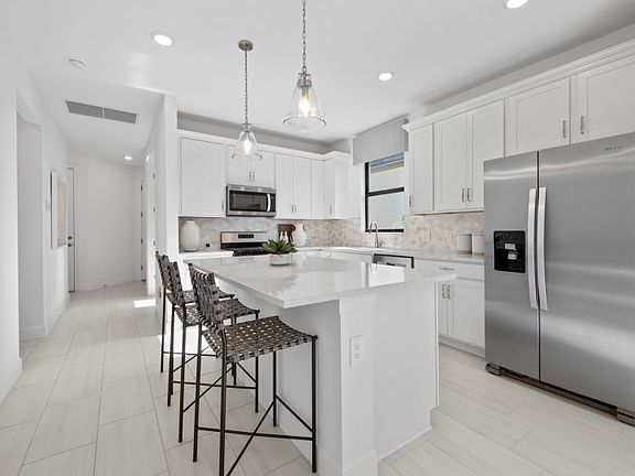 Kitchen with large center island and stainless steel appliances
