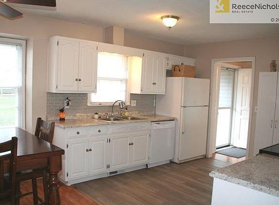 Updated kitchen with new countertops, glass tile backsplash and new paint.