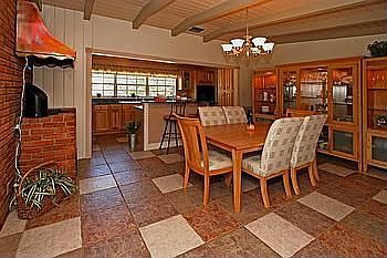 Warm hues grace the dining room.  Complete with indoor grill and copper hood.