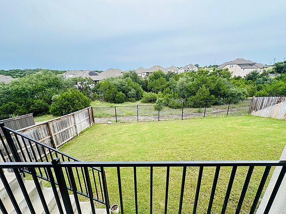 Large backyard with beautiful view from an elevated lot with green views. No neighbor on the back as well as on the side