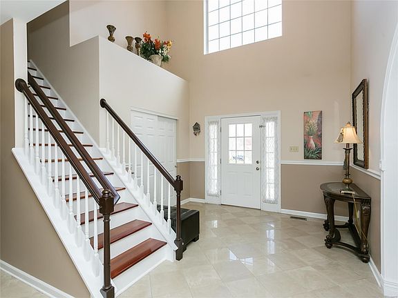 Entry foyer with Marble floors and open stair case.